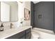 Modern bathroom featuring a gray tiled shower, stylish vanity with gold accents, and elegant fixtures at 1103 Boulevard Se Dr, Atlanta, GA 30317