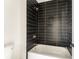 Modern bathroom featuring a black tiled shower with a gold shower head and trim at 1103 Boulevard Se Dr, Atlanta, GA 30317