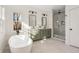 Bright bathroom featuring dual sink vanity, soaking tub, and walk-in shower at 1103 Boulevard Se Dr, Atlanta, GA 30317