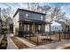 Modern two-story home with dark gray siding, black trim, and a fenced front yard at 1103 Boulevard Se Dr, Atlanta, GA 30317