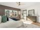 Sun-filled main bedroom boasts a panel accent wall, abundant natural light, and a barn door entry to the en suite at 1103 Boulevard Se Dr, Atlanta, GA 30317