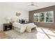 Serene main bedroom with hardwood floors, a stylish accent wall, and a large window overlooking greenery at 1103 Boulevard Se Dr, Atlanta, GA 30317