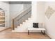 Modern staircase with wood treads, black railings, and white risers, adjacent to a contemporary designed wall at 1103 Boulevard Se Dr, Atlanta, GA 30317