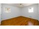 Well-lit bedroom with two windows, hardwood floors, and white walls at 1654 Deerfield Cir, Decatur, GA 30033