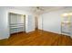 Bright bedroom showcasing hardwood floors, closet, and doorway to a bathroom at 1654 Deerfield Cir, Decatur, GA 30033