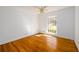 Bright bedroom featuring a window, hardwood floors, and white walls at 1654 Deerfield Cir, Decatur, GA 30033