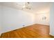 Spacious bedroom featuring hardwood floors, ceiling fan, and white walls at 1654 Deerfield Cir, Decatur, GA 30033