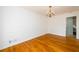 Spacious dining room featuring gleaming hardwood floors, fresh paint, and a classic chandelier at 1654 Deerfield Cir, Decatur, GA 30033