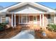 Inviting brick front porch with columns, painted door, and large window for ample natural light at 1654 Deerfield Cir, Decatur, GA 30033