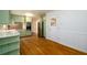 Well-lit kitchen with stainless steel appliances, light green cabinetry and hardwood floors at 1654 Deerfield Cir, Decatur, GA 30033