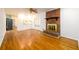 Bright living room boasting hardwood floors, brick fireplace, ceiling fan, and doorway to kitchen at 1654 Deerfield Cir, Decatur, GA 30033