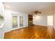 Spacious living room featuring a brick fireplace, hardwood floors, and sliding glass doors to sunroom at 1654 Deerfield Cir, Decatur, GA 30033