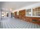 Spacious sunroom featuring patterned tile floors, multiple windows and brick accent wall at 1654 Deerfield Cir, Decatur, GA 30033