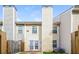 Townhome backyard view with fences, chimney, sliding glass doors, and air conditioning unit at 6347 Wellington Walk Way, Lithonia, GA 30058