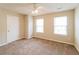 Bedroom showcasing neutral walls, plush carpeting, two windows, and a ceiling fan with light fixture at 6347 Wellington Walk Way, Lithonia, GA 30058