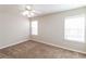 Sunny bedroom with neutral walls, cozy carpeting, and bright natural light at 6347 Wellington Walk Way, Lithonia, GA 30058