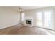 Bright living room featuring fireplace, ample natural light, and neutral carpet at 6347 Wellington Walk Way, Lithonia, GA 30058