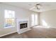 Comfortable living room with a decorative fireplace, ceiling fan, and natural light at 6347 Wellington Walk Way, Lithonia, GA 30058