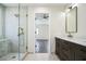 Bathroom featuring double sinks, stone countertops, dark wood cabinets, and a glass shower at 700 Hill Meadow Dr, Dacula, GA 30019