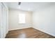 Neutral bedroom features hardwood floors, natural light, and closet at 700 Hill Meadow Dr, Dacula, GA 30019