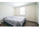 Bedroom featuring hardwood floors, neutral walls, a window with blinds, and closet with sliding doors at 700 Hill Meadow Dr, Dacula, GA 30019