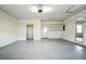 Spacious garage features painted floors, ample storage, and natural light at 700 Hill Meadow Dr, Dacula, GA 30019