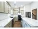 Modern kitchen with marble countertops, gray cabinets, and stainless steel appliances at 700 Hill Meadow Dr, Dacula, GA 30019