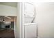 Stacked washer and dryer with a view into the living room with built in shelves at 700 Hill Meadow Dr, Dacula, GA 30019