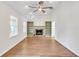 Bright living room features built-in shelves, a fireplace, and wood floors at 700 Hill Meadow Dr, Dacula, GA 30019