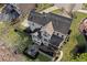 Aerial view of house showing backyard patio with outdoor fireplace, screened porch, and beautifully landscaped yard at 718 Park Haven Ln, Canton, GA 30115