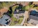 Aerial view of a house with mature trees, manicured lawn, outdoor fire place and driveway at 718 Park Haven Ln, Canton, GA 30115