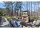 Cozy outdoor space with a stone fireplace, comfortable seating, and a manicured lawn at 718 Park Haven Ln, Canton, GA 30115