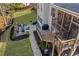 Aerial view of the backyard featuring a stone patio with outdoor seating and a fire pit at 718 Park Haven Ln, Canton, GA 30115