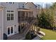 Exterior view of a home featuring a wooden staircase, screened-in porch, and an outdoor space at 718 Park Haven Ln, Canton, GA 30115