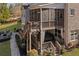 Multi-level backyard featuring a wooden staircase, patio with fire pit, and a screened-in porch at 718 Park Haven Ln, Canton, GA 30115