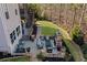 Aerial view of a backyard with a beautiful stone patio and an outdoor fireplace surrounded by nature at 718 Park Haven Ln, Canton, GA 30115