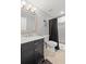 Bathroom featuring vanity with a dark cabinet, marble counter, toilet, and a stand up shower at 718 Park Haven Ln, Canton, GA 30115