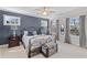 Comfortable bedroom featuring a wrought iron bed frame, two windows, and calming blue accent wall at 718 Park Haven Ln, Canton, GA 30115