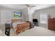 This light filled bedroom offers a ceiling fan, multiple windows, and sports themed decor at 718 Park Haven Ln, Canton, GA 30115