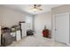 Well lit bedroom with neutral walls and carpet has one window and white door at 718 Park Haven Ln, Canton, GA 30115