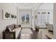 Charming entryway with french doors, bench seating, and natural light filtering through the windowed dining room at 718 Park Haven Ln, Canton, GA 30115