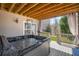 Covered outdoor hot tub on a wooden deck featuring outdoor lighting and privacy curtains at 718 Park Haven Ln, Canton, GA 30115