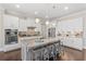 Modern kitchen with gray cabinets, a large island with seating, and stainless steel appliances at 718 Park Haven Ln, Canton, GA 30115