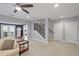 Spacious living room with neutral walls, light carpet, a staircase, and an exterior doorway to the back deck at 718 Park Haven Ln, Canton, GA 30115