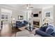 Comfortable living room featuring a fireplace, hardwood floors, and a view of the entryway at 718 Park Haven Ln, Canton, GA 30115