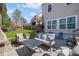 Outdoor patio featuring a stone fireplace, comfortable seating, and a view of the backyard at 718 Park Haven Ln, Canton, GA 30115