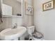 Cozy half-bathroom with pedestal sink, decorative mirror, and stylish décor at 2311 Fall Creek Lndg, Loganville, GA 30052