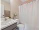 Cozy bathroom featuring a white shower curtain and vanity with a grey cabinet at 2311 Fall Creek Lndg, Loganville, GA 30052