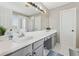 Bathroom featuring double vanity, large mirror, shower, and bathtub at 2311 Fall Creek Lndg, Loganville, GA 30052