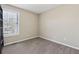 Empty bedroom featuring neutral paint, carpet flooring, and natural light at 2311 Fall Creek Lndg, Loganville, GA 30052